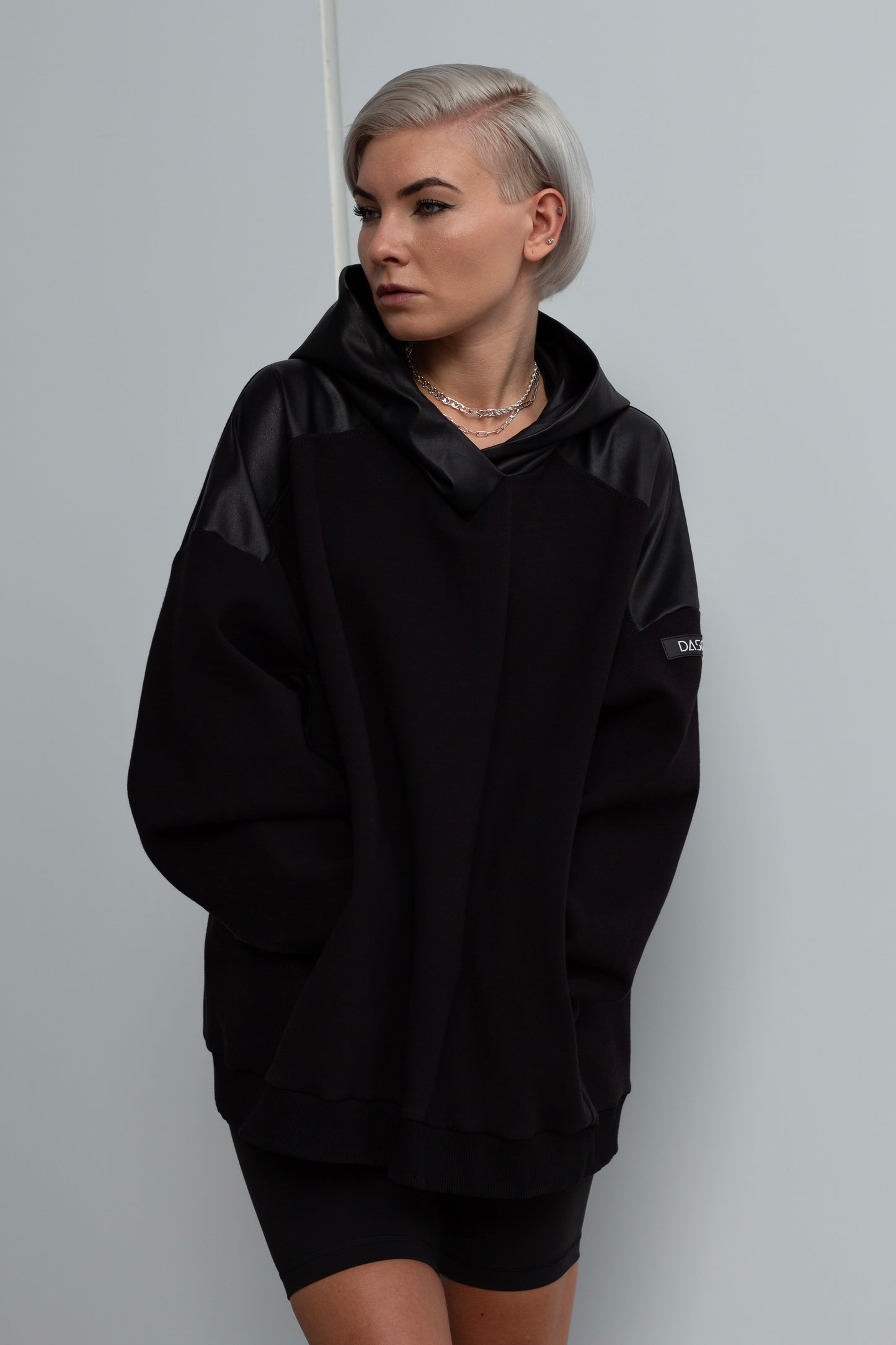 H01 | Oversized black hoodie with black faux leather inserts